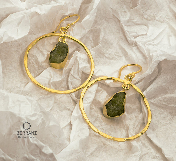 Handmade 18k gold-plated earrings featuring raw green aventurine stones, set in textured hoops, creating a bold and earthy statement piece.