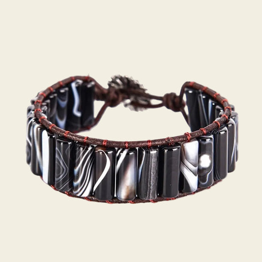 Adjustable bracelet made with smooth onyx tubes and leather cord, offering a modern and stylish natural stone design. Perfect for casual or everyday wear.