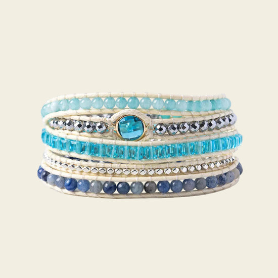 Handmade adjustable bracelet featuring layers of amazonite, blue crystals, and silver accents, with a striking blue crystal centerpiece, perfect for a boho-chic look.