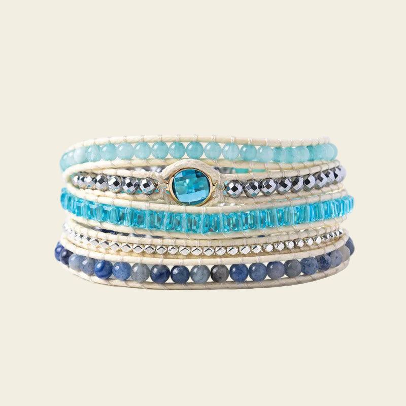 Handmade adjustable bracelet featuring layers of amazonite, blue crystals, and silver accents, with a striking blue crystal centerpiece, perfect for a boho-chic look.