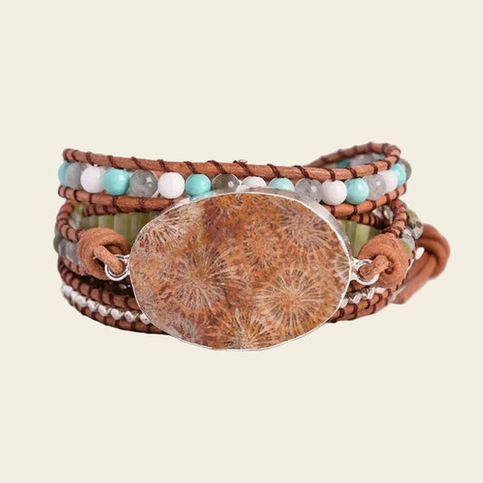 Close-up of the handmade Petoskey stone bracelet, featuring earthy tones with leather wraps, turquoise, and agate beads, offering a stylish boho look for all occasions.