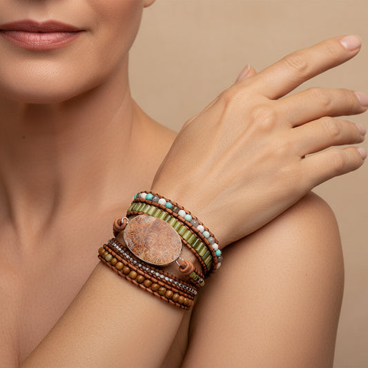 Handmade Petoskey stone bracelet on a leather wrap with turquoise, jade, and brown wood beads, featuring a boho style, perfect for casual or elegant wear.