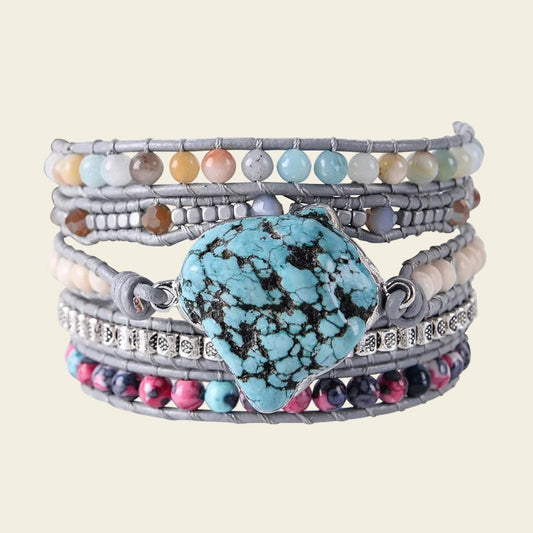 Five-layer adjustable bracelet featuring a bold turquoise stone centerpiece, complemented by vibrant natural stones like agate, jade, and pink marble, perfect for a boho-chic style.