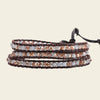 Handmade 3-layer wrap bracelet with crystal beads and leather cord, adjustable closure, bohemian style.