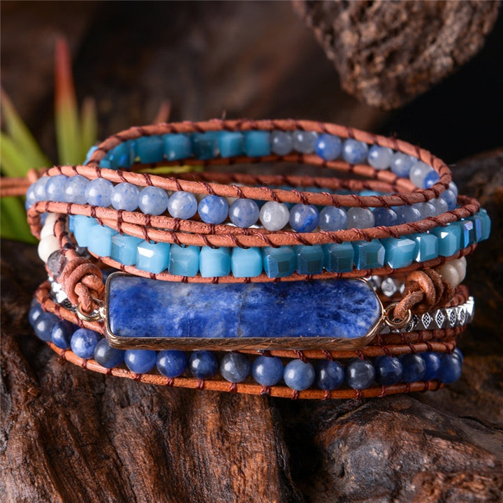 Adjustable handmade 5-layer Sodalite bracelet with blue beads, leather cords, and natural stone accents, perfect for boho fashion.