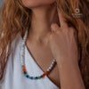 Close-up of a model wearing a handmade 7 Chakra natural stones necklace with vibrant colored beads.