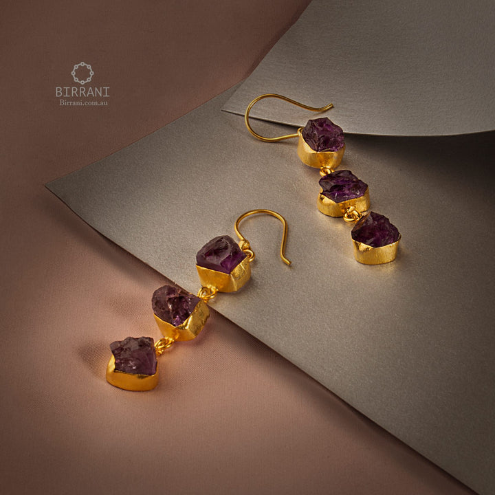 Elegant handmade gold-plated earrings with Amethyst stones, offering a luxurious touch to your style with a chic, dangling design.