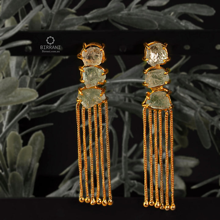 Elegant handmade gold-plated earrings with three aquamarine stones and cascading tassels, adding a stylish touch to any outfit.