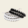 Handmade adjustable bracelet featuring black and white Agate beads, woven with black cord, offering a modern and stylish accessory with a monochrome color scheme.