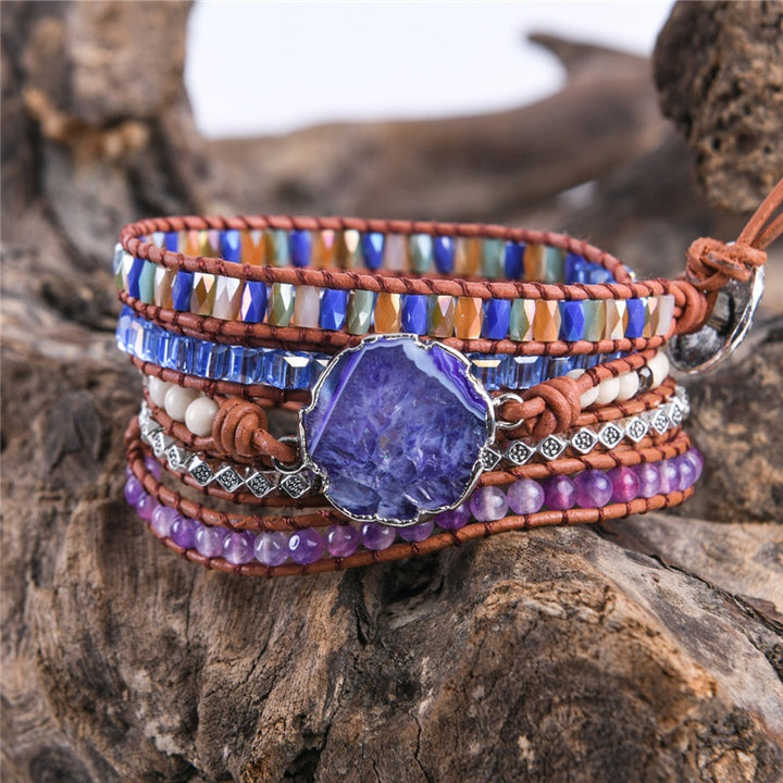 Handmade adjustable bracelet featuring a stunning grape agate slice centerpiece, with layers of amethyst, multicoloured beads, and silver accents, offering a bold boho look.