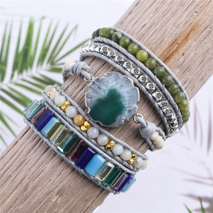 Handmade adjustable bracelet featuring natural moss agate slice, green beads, metallic accents, and colourful stones in a 5-layer design, perfect for boho-style lovers.