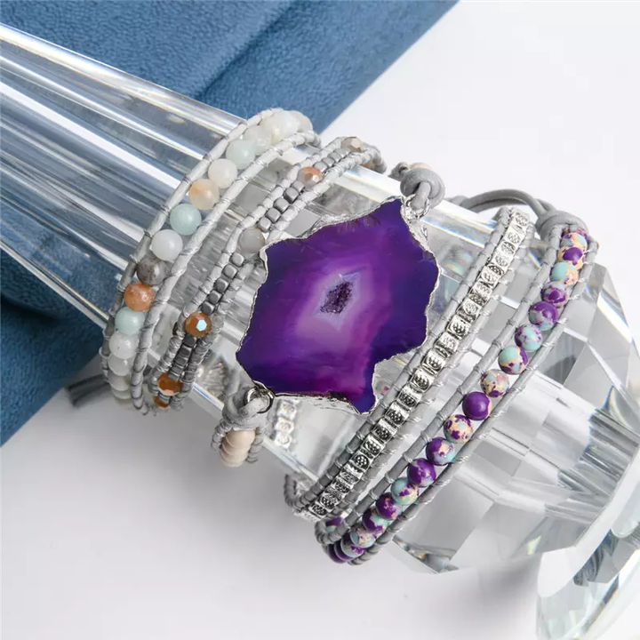 Handmade wrap bracelet featuring a stunning amethyst geode centerpiece, surrounded by natural stones and silver-plated accents, perfect for boho and casual styles, adjustable fit.