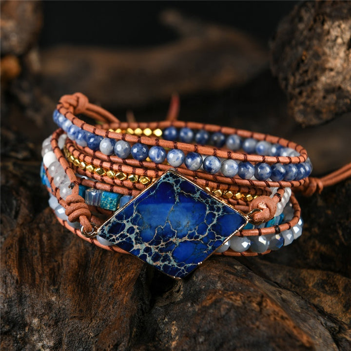 Handmade boho bracelet with a Lapis Lazuli centerpiece, Sodalite, turquoise, and gold beads, featuring a leather strap, perfect for a boho-style gift.