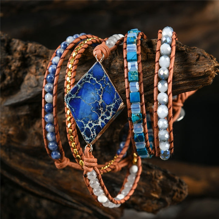 Handmade adjustable bracelet featuring a Lapis Lazuli centerpiece, combined with Sodalite and turquoise beads, on a leather strap for a unique boho look.