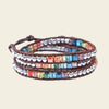 Handmade 3-layer multicolour crystal wrap bracelet on brown leather, featuring vibrant hues of red, orange, yellow, blue, and green, with a boho chic design.
