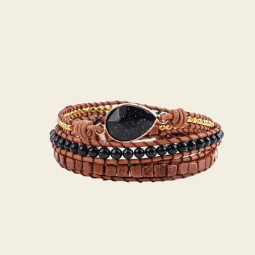 Handmade 3-layer wrap bracelet featuring a tear-drop Onyx gemstone, black beads, and gold accents, crafted with natural leather, perfect for a boho gift.