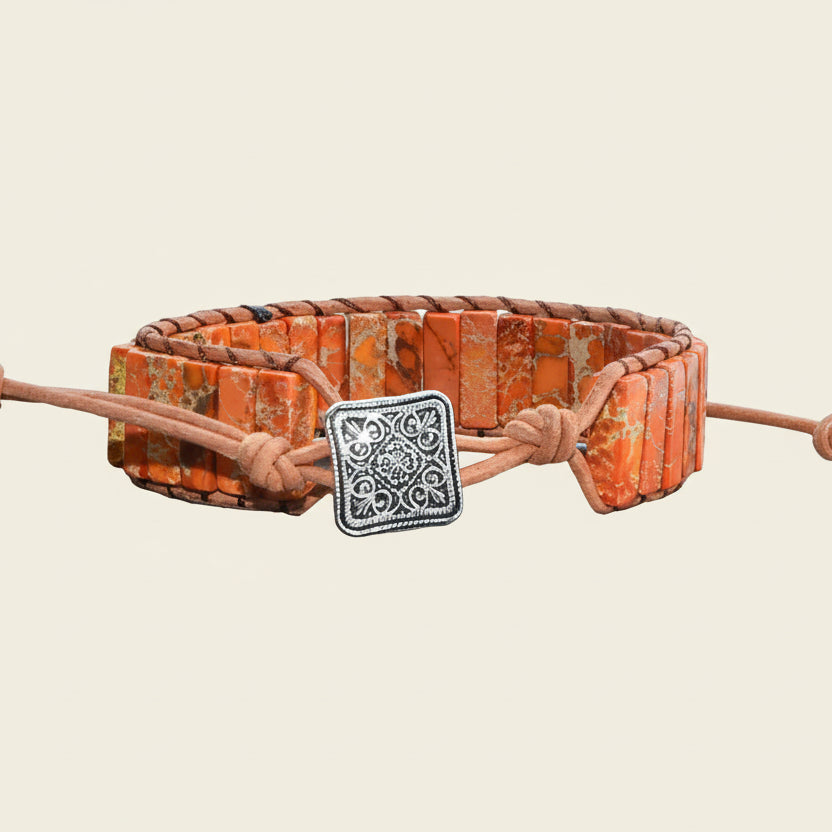 Handmade boho bracelet featuring Red Sedona Jasper rectangular beads in warm orange and beige hues with an adjustable leather band and antique silver clasp.