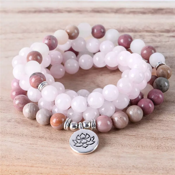Set of handmade rose quartz bracelets with soft pink gemstones and silver spacers, featuring a lotus charm, perfect for boho-style and healing jewellery.