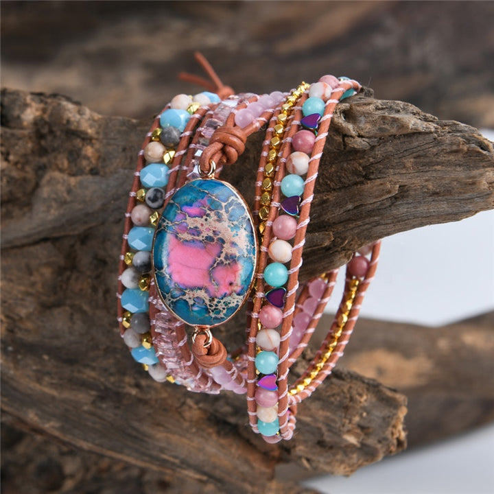 Handmade adjustable bracelet featuring a Ruby In Kyanite stone centerpiece with soft pink, turquoise, and golden beads, finished with a vintage button closure.
