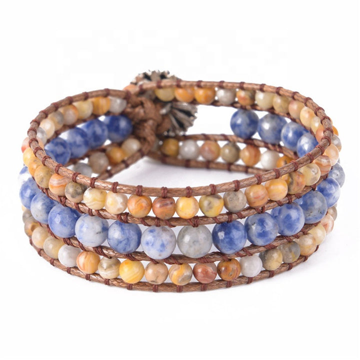 Handmade bracelet featuring Blue Lace Agate and Yellow Jasper stones, showcasing a multi-strand design on a braided cord, with earthy tones.