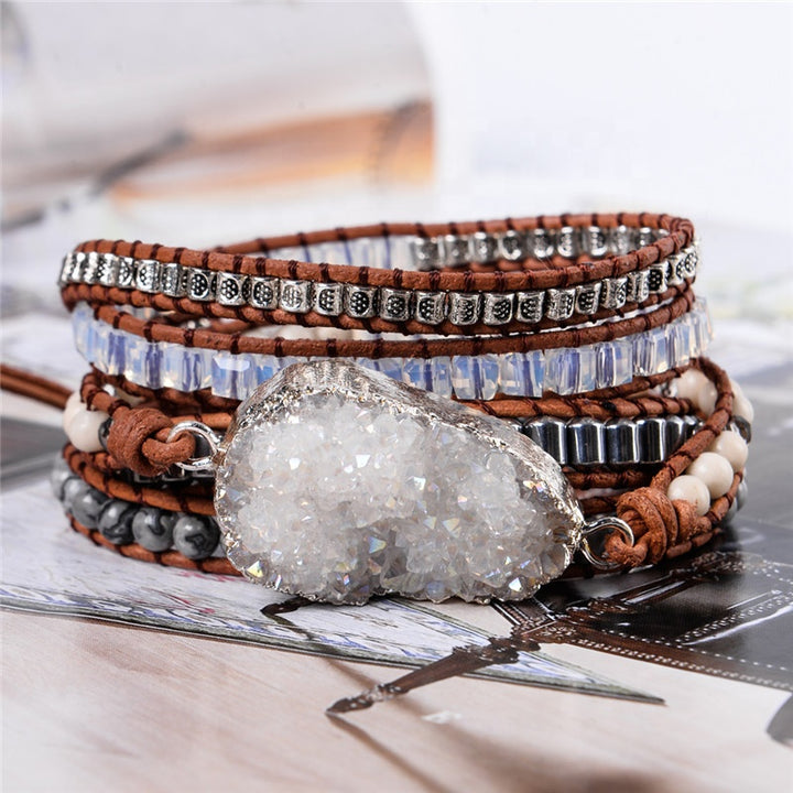 Five-layer handmade bracelet featuring a clear quartz druzy centerpiece, metallic silver beads, and brown leather, creating a stylish and unique accessory.
