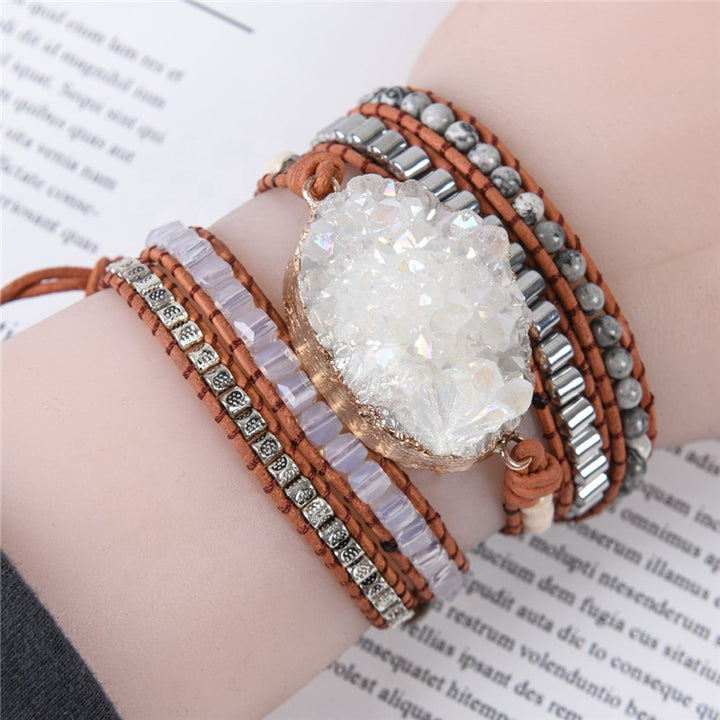 Five-layer handmade bracelet featuring a large clear quartz druzy stone centerpiece, metallic accents, and brown leather for a stylish and unique accessory.