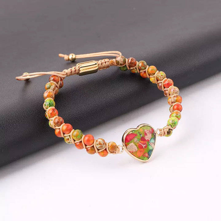 Handmade adjustable bracelet featuring multicolored natural stone beads with a vibrant heart-shaped centerpiece, accented with gold-tone details.