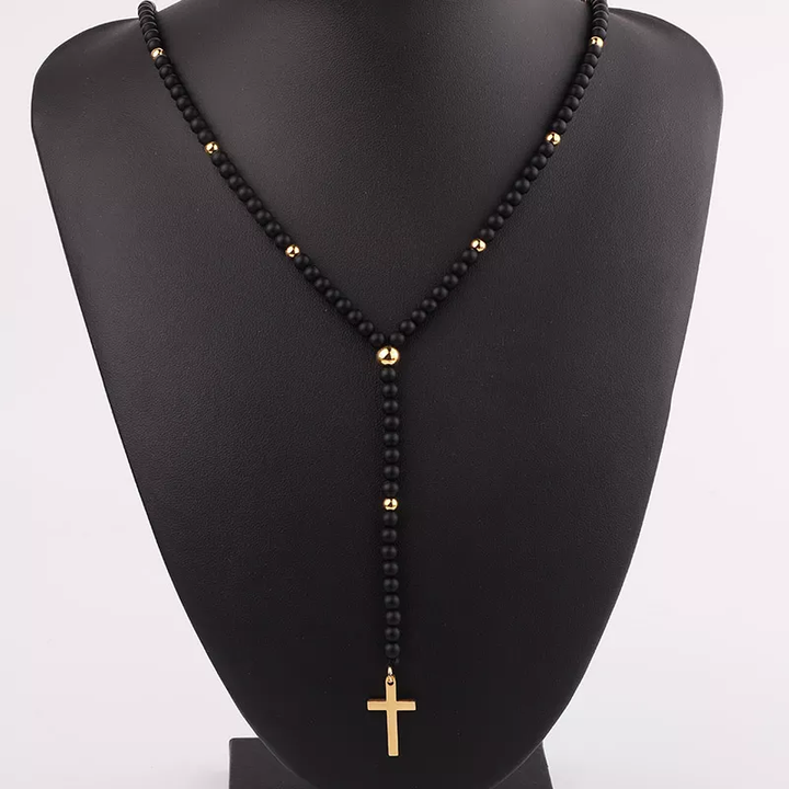 Handmade matte onyx necklace with gold bead accents and a gold cross pendant, perfect for casual or formal wear.
