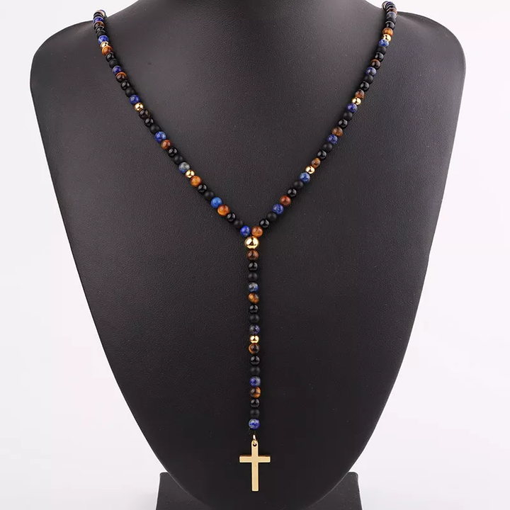 Handmade necklace featuring natural stones, including black onyx and tiger's eye beads, with a gold cross pendant.