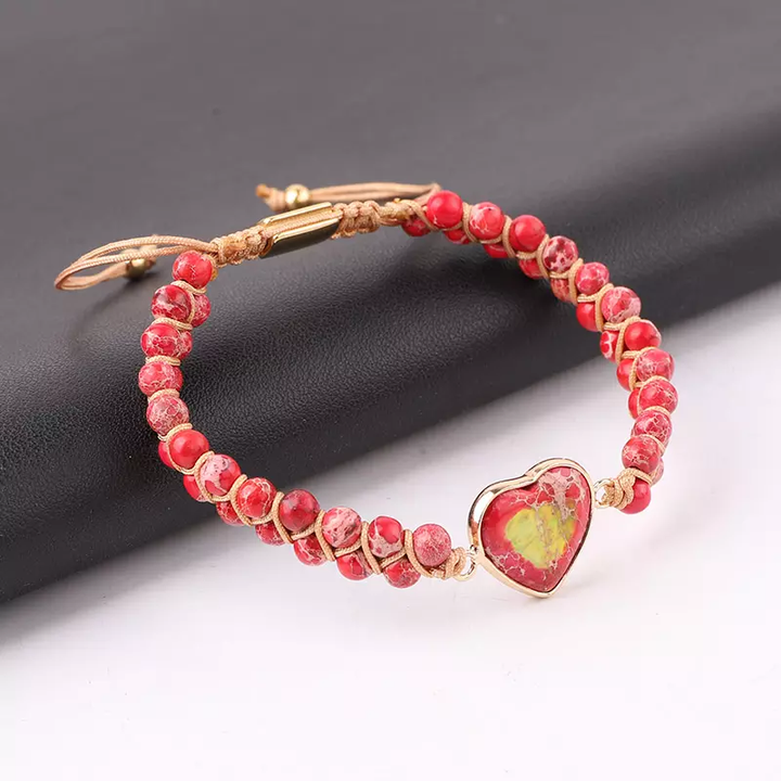 Handmade adjustable bracelet featuring red Jasper beads and a heart-shaped stone centerpiece, set with gold-tone accents.