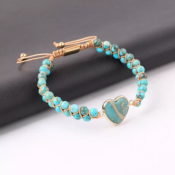 Handmade adjustable bracelet featuring Turquoise beads with a heart-shaped stone centerpiece, accented with gold-tone details.