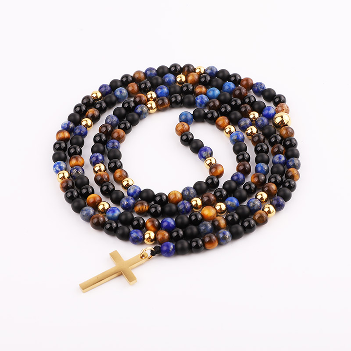 Handmade necklace featuring lapis lazuli, tiger’s eye, and black onyx beads, accented with gold beads and a gold cross pendant.