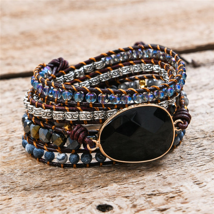 Handmade adjustable 5-wrap bracelet featuring black onyx and crystal beads with silver accents, perfect for stylish, earthy fashion.