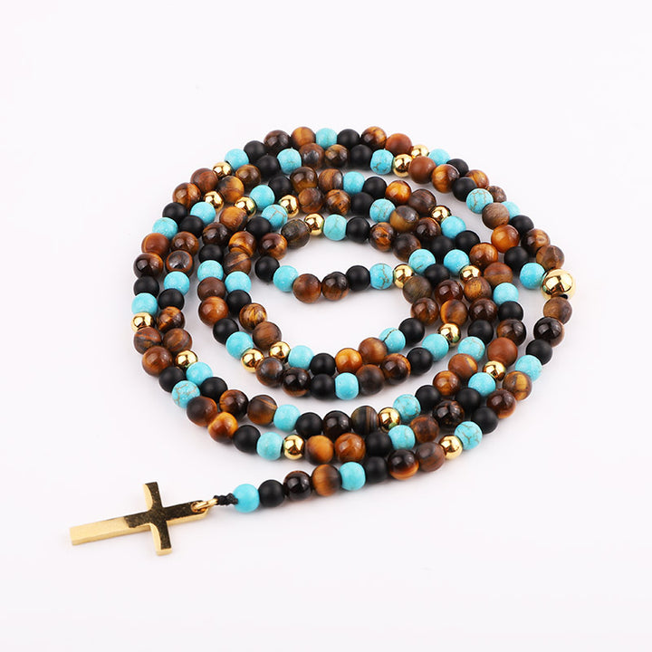 Handmade necklace with tiger’s eye, black onyx, and turquoise beads, accented with gold beads and a gold cross pendant.